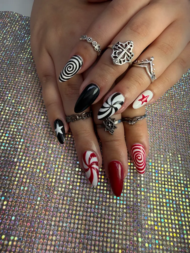 Peppermint Swirl Stiletto nail design by Zuzu Nails & Beauty in Jacksonville, Florida